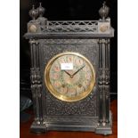 A late 19th Century mantel clock in ebonised case decorated cut card work, turned finials and
