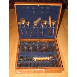 A canteen of gilt bronze cutlery and flatware, in wooden case