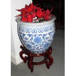 A Chinese blue and white porcelain fish bowl decorated scrolling foliage, 16" dia, with wooden stand