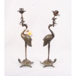 A pair of oriental bronze candlesticks cast as cranes on tortoises, 13" high