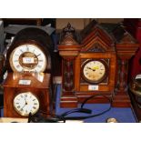 An early 20th Century arch top mantel clock in stained wooden case, a drum cased mantel clock in