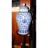 A Chinese blue and white mei ping porcelain vase and domed cover decorated scrolling foliage, on