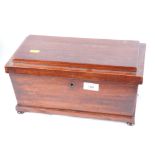 A 19th Century mahogany sarcophagus-shaped tea caddy with two tea compartments and central glass