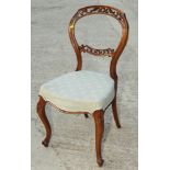 A Victorian walnut balloon back dining chair with pierced decoration, retailers label for T R