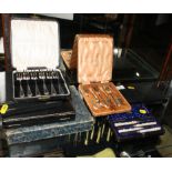 A cased set of Elkington's plated nut picks with mother-of-pearl handles and other cased sets of