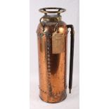 A Walker Perfect fire extinguisher in copper case