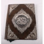 An Edwardian embossed silver mounted leather folder and an ivory page turner with silver handle