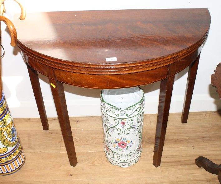 A 19th Century mahogany and box line inlaid semicircular fold-over top tea table, on square taper