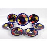 A Moorcroft "Wisteria" dessert service comprising six plates, 7" dia, and a shallow bowl, 8" dia,