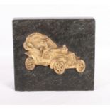 A black granite bookend mounted with a gilt bronze vintage motor car