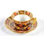 A miniature Royal Crown Derby Imari pattern tea cup and saucer