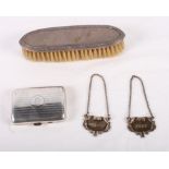 A silver cigarette case, a silver backed clothes brush and two silver decanter labels