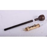 A carved bone blowpipe dart holder with darts and a plain turned wood knobkerrie