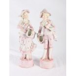 A pair of late 19th Century continental porcelain figures in period costumes with baskets, 14 1/2"