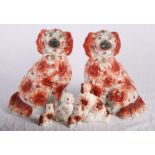 A pair of 19th Century Staffordshire spaniels, 12" high, and four smaller similar (damages)