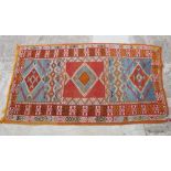 A Bokhara rug decorated eighteen lozenge-shaped guls on a red ground with three border stripes,