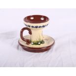 A Torquay Longpark pottery inkstand with inkwell, four candlesticks, taper stick, a two-handled