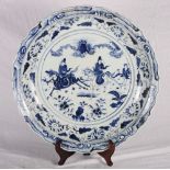 A Chinese shallow blue and white porcelain bowl, centre panel decorated figures on horseback, 24"