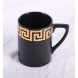 A Portmeirion coffee set for six decorated gilt Greek key pattern on a black ground