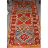 A North African gold wash tribal rug decorated three diamond lozenges and bands of camels, 41" x 74"