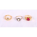 An Edwardian 18ct gold, opal and diamond dress ring, a gold and ruby dress ring and a gold cluster