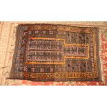 A Turkish prayer rug decorated panels of stylised leaves on a red ground with orange border stripes,