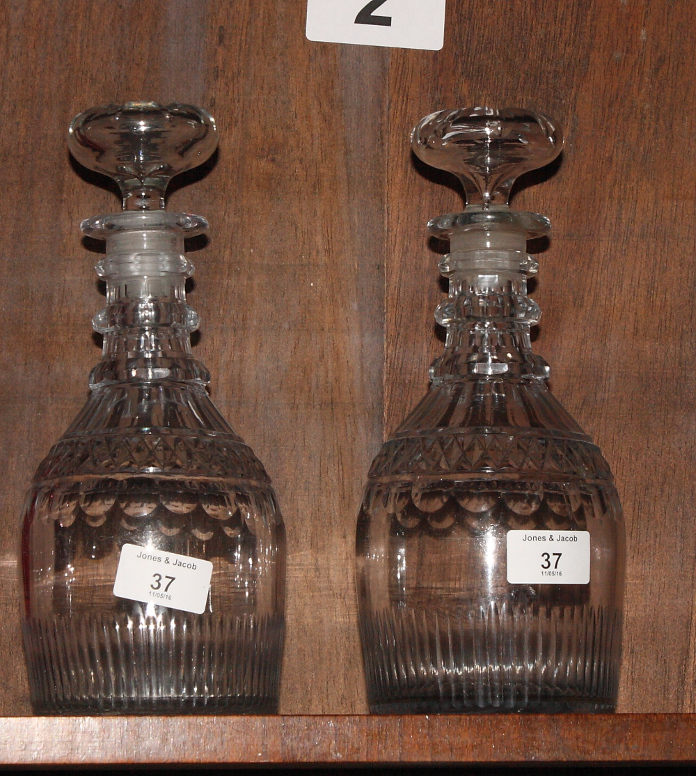 A pair of Georgian decanters with three-ring necks, base cut flutes