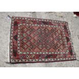 A Persian rug decorated all-over trellis design on a fawn ground, 35" x 25" approx