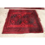 A Bokhara rug decorated two medallions on a red ground, 47" x 43" approx (worn)