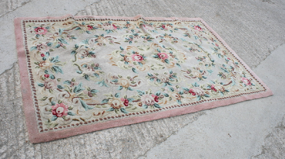 A wool contour pile rug decorated with all-over floral design, 82" x 48" approx