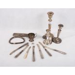 Three silver candlesticks and a small quantity of scrap silver