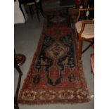 An old Persian runner and two smaller rugs (all damaged)