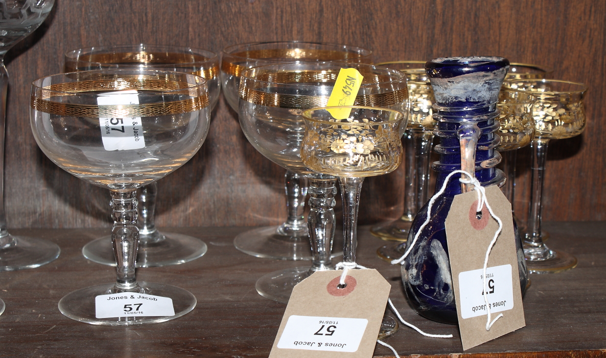 A set of six late 19th Century gilt and engraved liqueur glasses, four similar champagne slippers