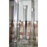 A glass lily vase, 36" high, a pair of similar smaller vases and one other