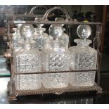 A silver plated three-bottle tantalus fitted three cut glass decanters and stoppers