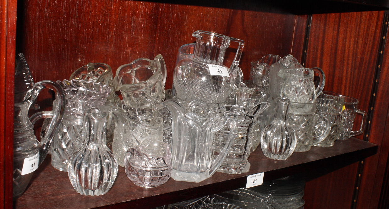 A collection of mainly moulded glass jugs