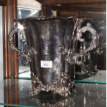 A silver plated wine cooler with scrolled handles and applied foliate decoration