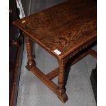 An oak occasional table of 17th Century design, on turned and stretchered supports, 26" wide, and an
