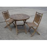 A bamboo circular folding garden table and two chairs