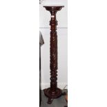 A 19th Century carved mahogany torchere, on tripod splay supports