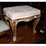 A 19th Century carved gilt gesso decorated serpentine stool, on cabriole supports, 18" wide