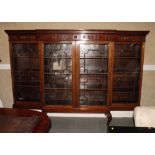 A late 19th Century mahogany breakfront display cabinet of Chippendale design enclosed four glazed