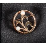 An Art Nouveau yellow gold and pearl mounted floral brooch