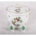 A Herend porcelain ice bucket decorated birds and butterflies and a pair of Herend condiments
