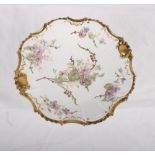 A Limoges dessert service, centres painted purple flowers, gilt edged, comprising ten dessert