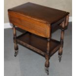 An oak drop leaf tea trolley and a low table on castors