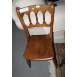 A set of four Victorian "Gothic" Windsor chairs with panel seats, on turned and stretchered