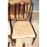 A pair of Edwardian walnut and line inlaid side chairs with stuffed over seats
