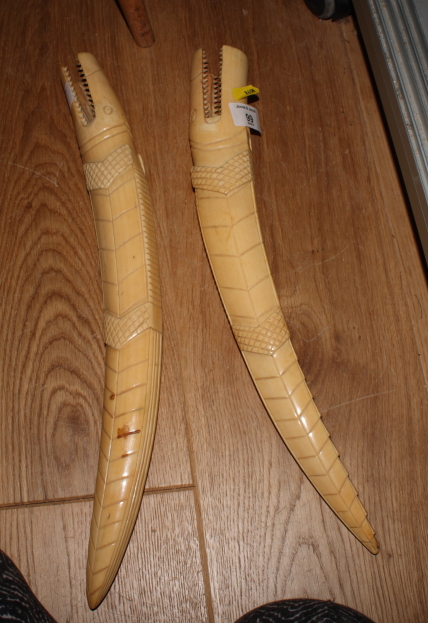 A pair of early 20th Century African carved ivory tusks formed as crocodiles, 16" long