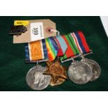 A set of five WWI and WWII medals on bar and a WVS badge